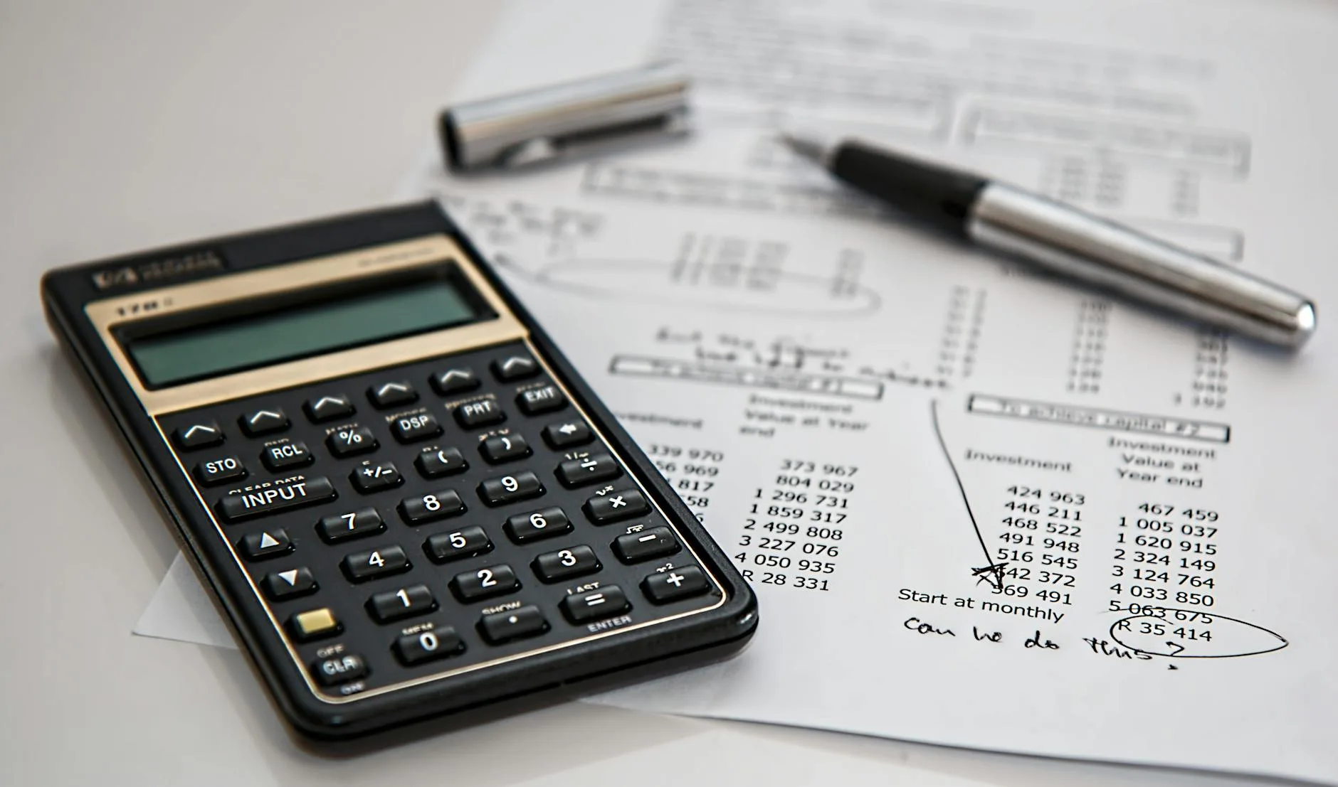 Calculator beside documents used to review tuition costs