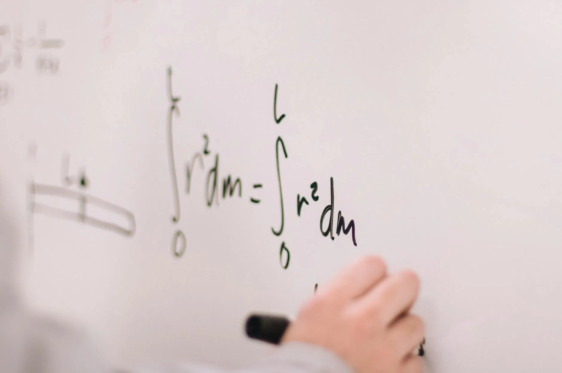 Teacher illustrating an equation on a board