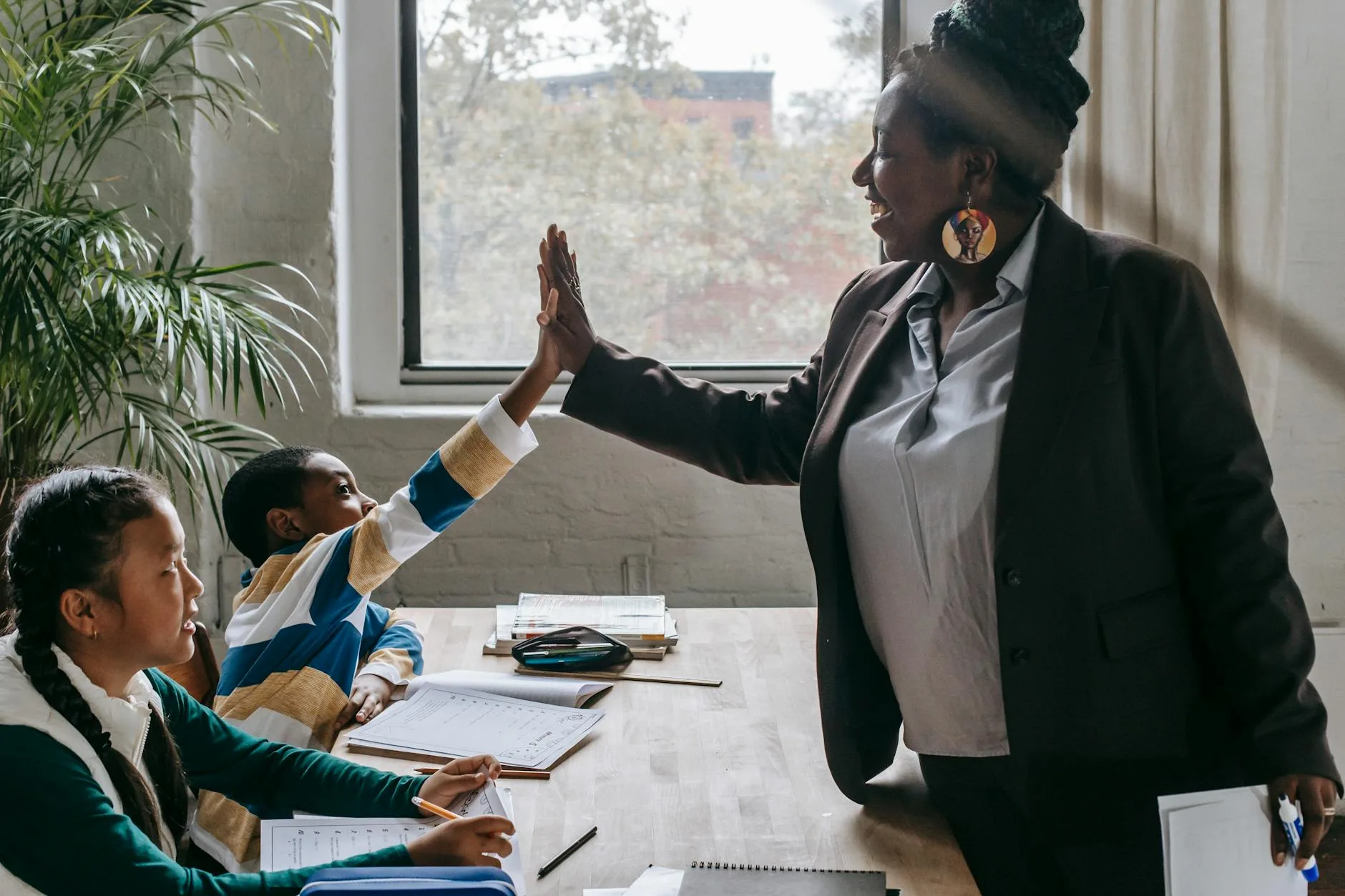 Teacher helping younger students learn