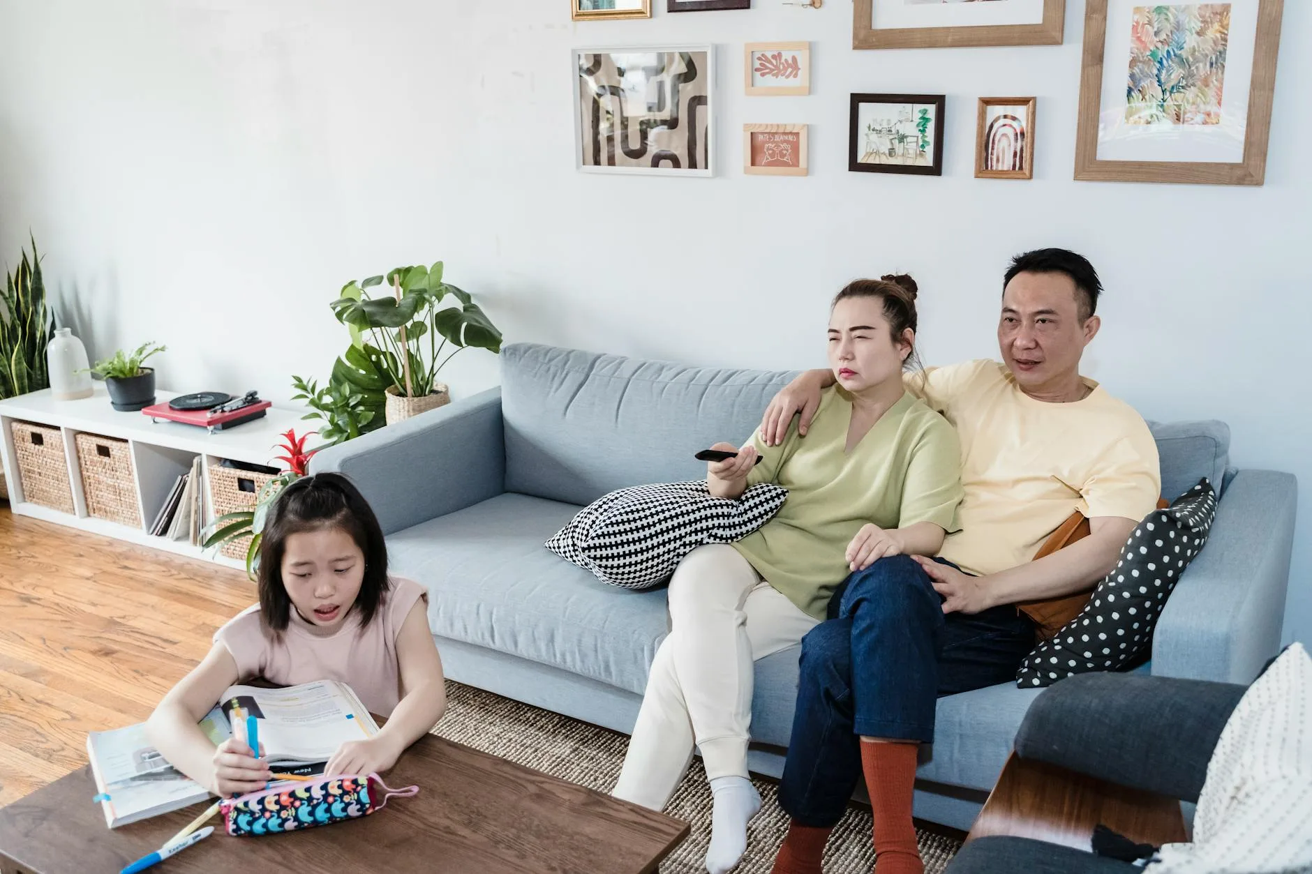Parent helping child with school homework at home